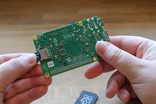 The microSD card going into the slot under the Pi