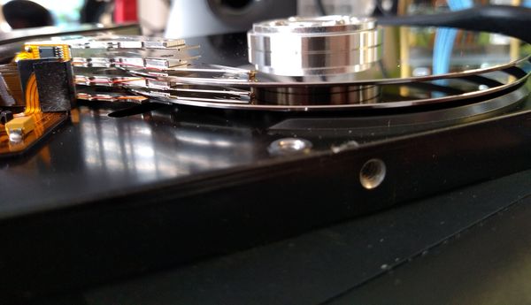 Side view of an opened 3.5-inch hard disk drive showing two platters and four heads