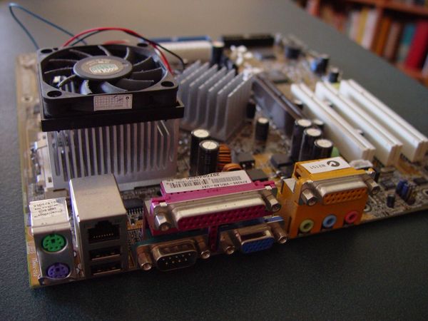 An ATX-format computer motherboard with CPU and cooling fan installed